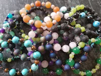 a group of bracelets with different colored beads